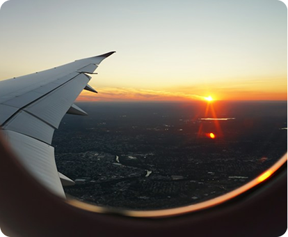 View of an airplane wing at sunset from a window seat